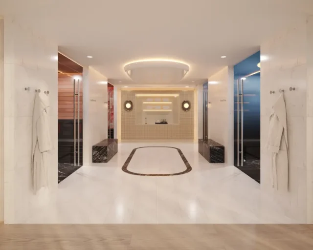 A rendering of a marble-lined recovery suite, with robes hanging at the entrance, wood-lined and glass-fronted cabins on either side, and a recessed plunge pool at the centre.